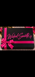 Wicked Smooth limited-edition holiday gift box in black with hot pink ribbon